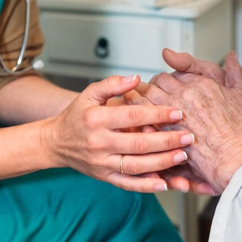Doctor giving encouragement to elderly patient Doctor giving encouragement to elderly patient